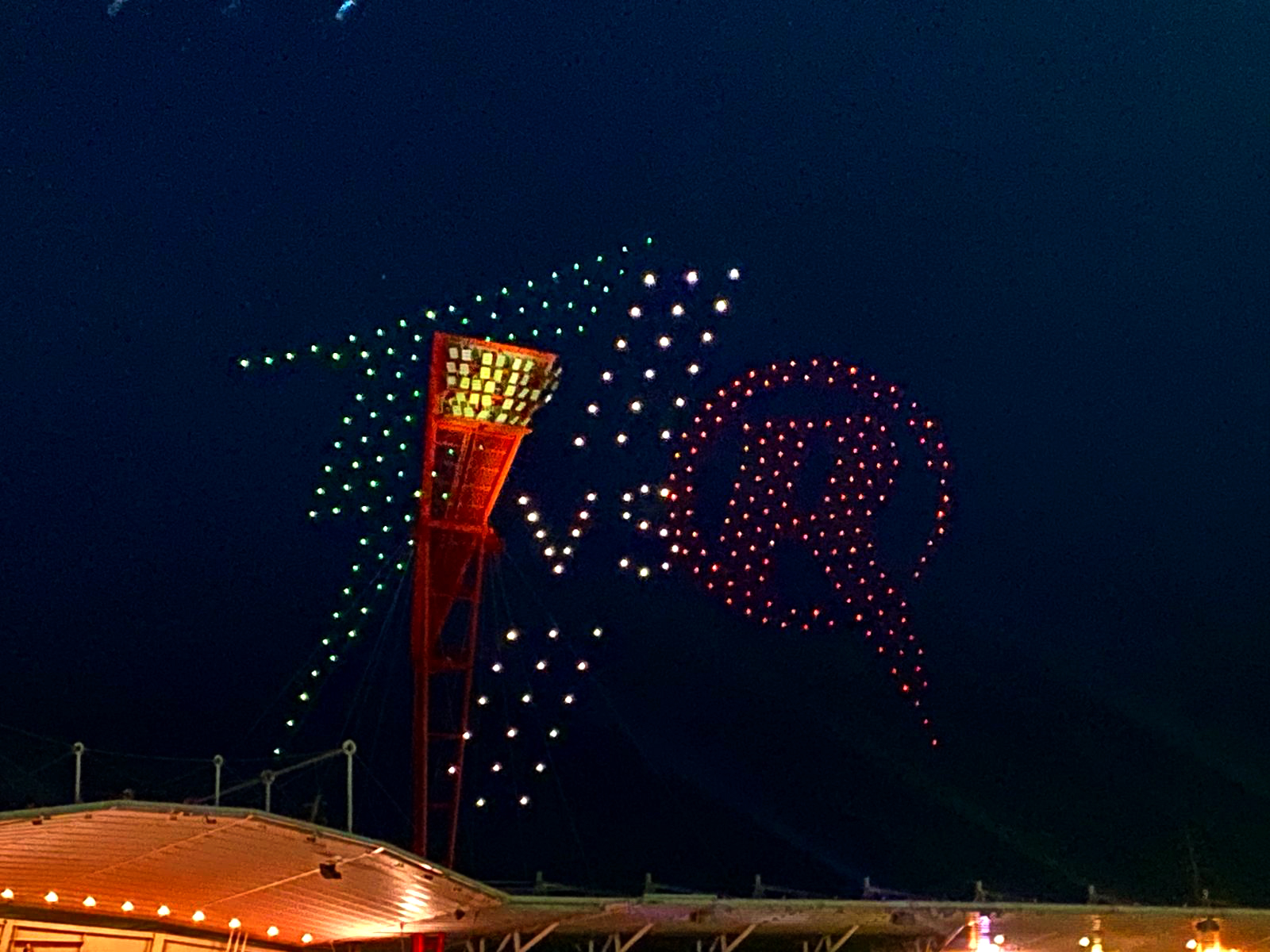 Drone light display featuring the Melbourne Renegades logo in red and green above the Sydney Cricket Ground during a Big Bash League event.