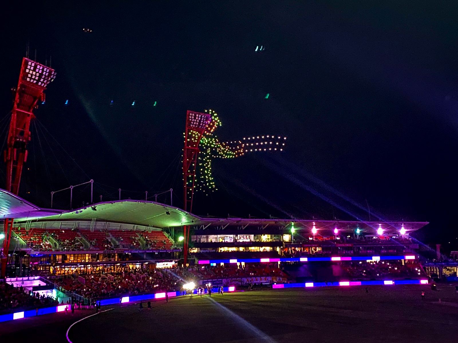 Drone light display forming a vibrant figure above the brightly lit Sydney Cricket Ground during a Big Bash League event, captivating the audience.