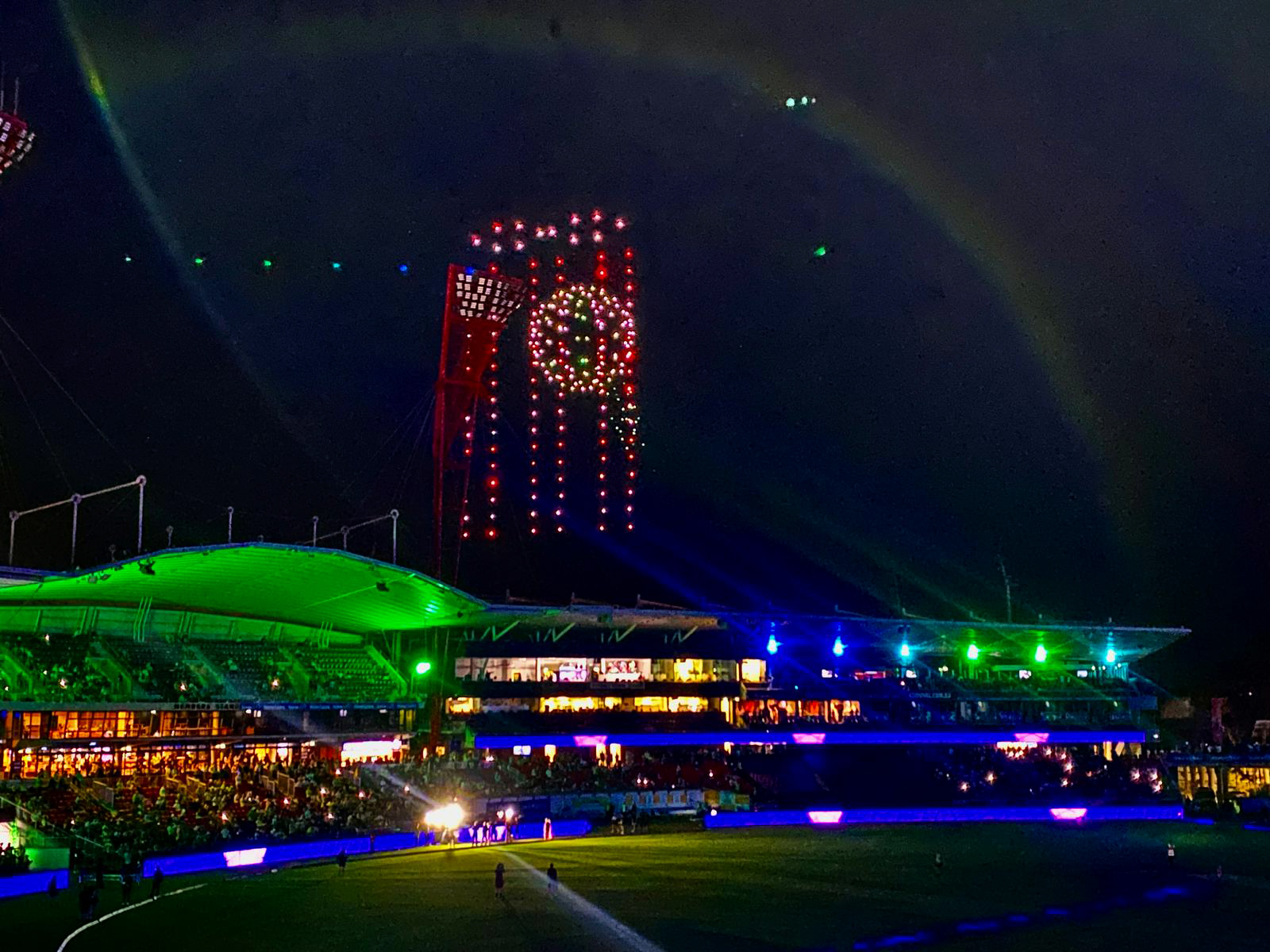 Drone light show displaying colorful patterns above Sydney Cricket Ground during a vibrant Big Bash League event, dazzling the audience.